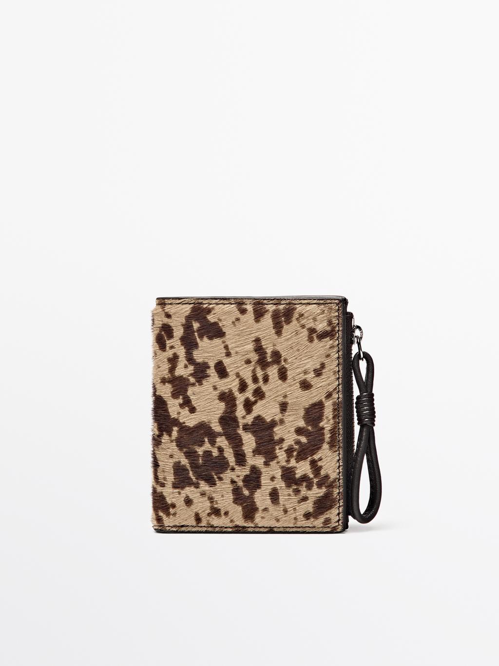 Animal print hair on leather wallet