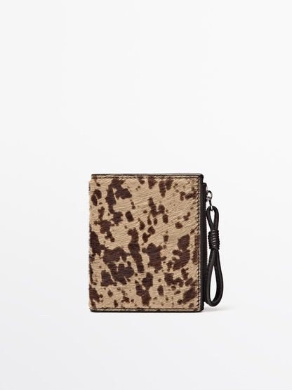 Animal print hair on leather wallet