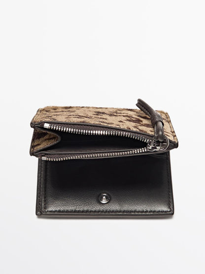 Animal print hair on leather wallet