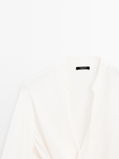 Blouse with knotted neckline and brooch detail