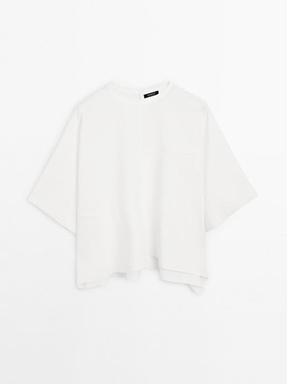 Short cape with seam details