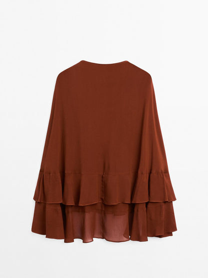 Cape-style blouse with ruffles