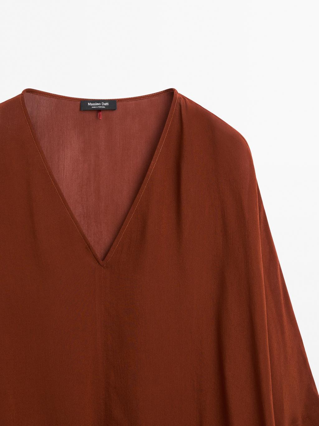 Cape-style blouse with ruffles