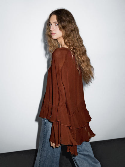 Cape-style blouse with ruffles