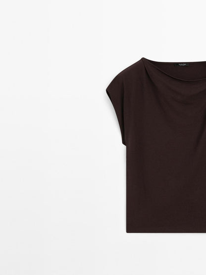 Draped neckline top with brooch detail