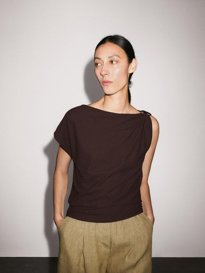 Draped neckline top with brooch detail